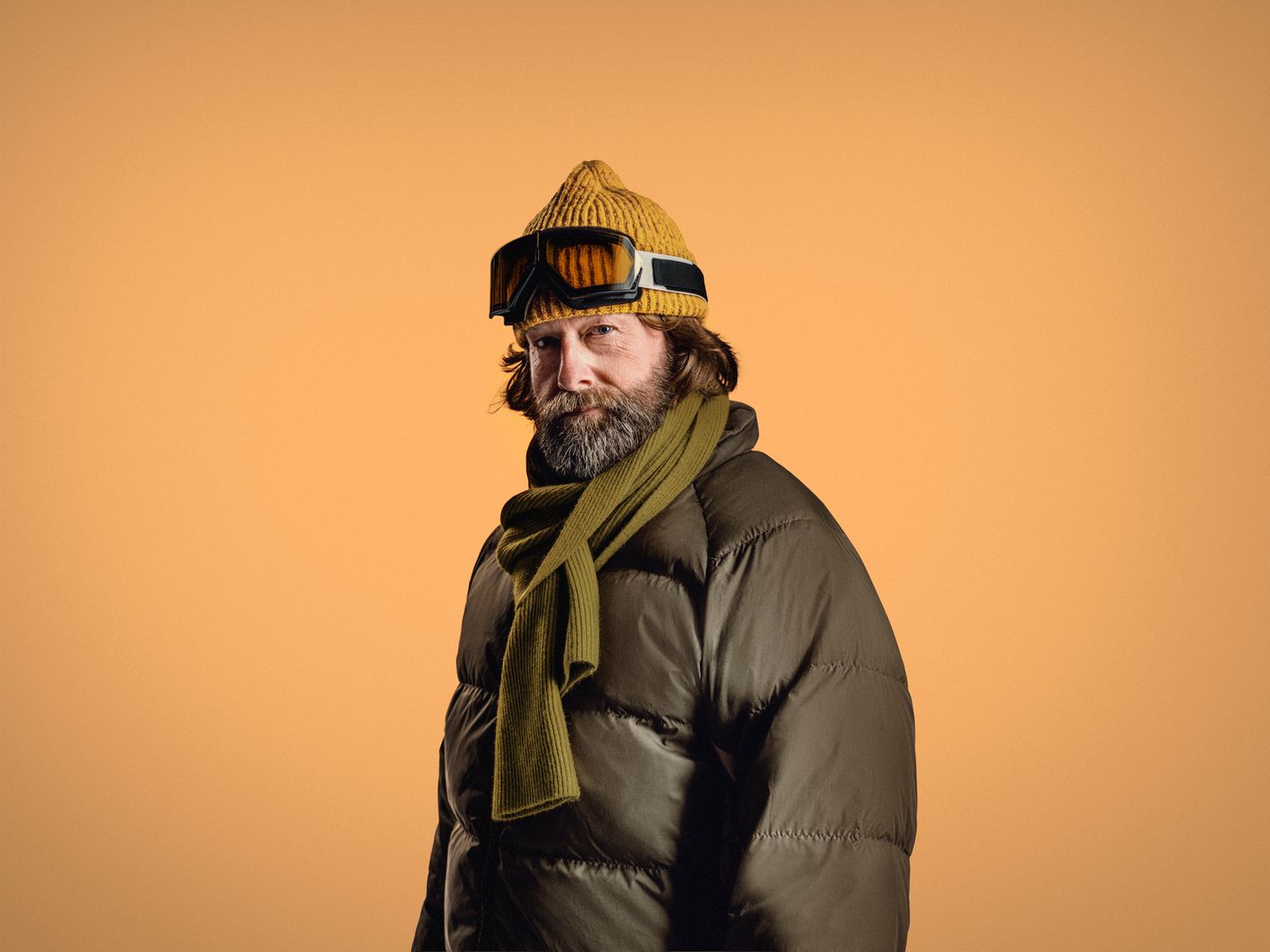Swedish man named Eric wearing ski gear in front of orange background.