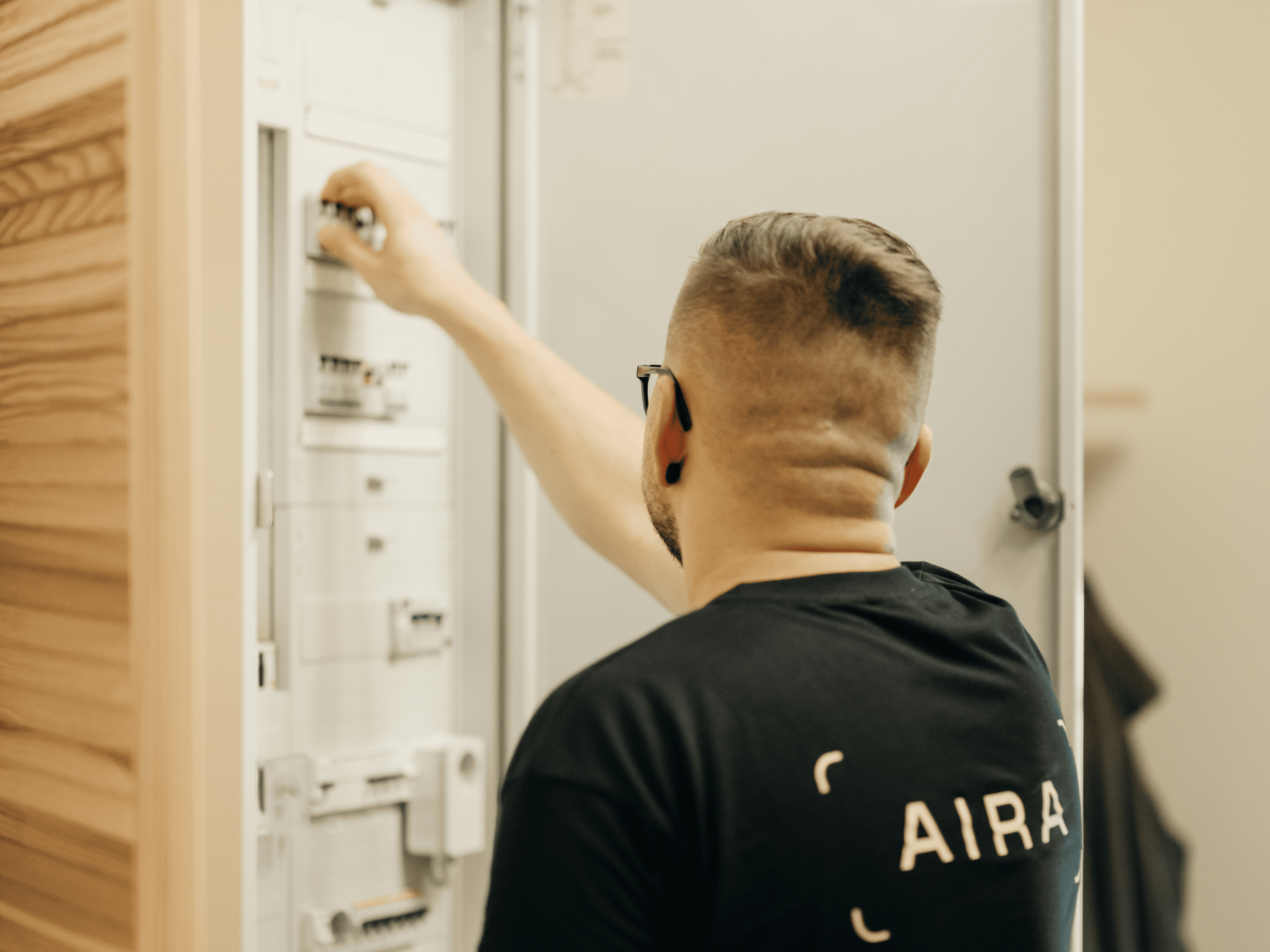 An Aira employee at a fuse box
